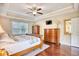 This spacious bedroom features wood floors, a ceiling fan, and a large window at 128 Belclare Way, Longs, SC 29568