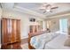 This bedroom features wood floors and classic decor, with an open door to another room at 128 Belclare Way, Longs, SC 29568