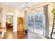 Dining area with patio access, hardwood floors, and open flow to other living spaces at 128 Belclare Way, Longs, SC 29568