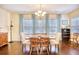 Light-filled dining room with hardwood floors and matching table and chairs at 128 Belclare Way, Longs, SC 29568