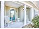 Inviting covered front porch featuring rocking chairs and pleasant decor at 128 Belclare Way, Longs, SC 29568