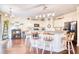 Open-concept kitchen featuring granite countertops, white cabinets, and a wine storage unit at 128 Belclare Way, Longs, SC 29568