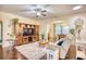 Comfortable living room with a ceiling fan, hardwood floors, and a view into the dining area at 128 Belclare Way, Longs, SC 29568