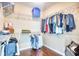 The walk-in closet is complete with custom shelving and hardwood floors at 128 Belclare Way, Longs, SC 29568