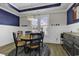 Charming dining room features a round table and blue accent wall at 130 Black Water Dr., Murrells Inlet, SC 29576