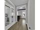 Bright and airy hallway with hardwood floors and French doors leading to the porch at 130 Black Water Dr., Murrells Inlet, SC 29576