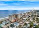 Wide beachfront view of the condo complex featuring nearby restaurants and shopping at 1321 S Ocean Blvd. # 1101, North Myrtle Beach, SC 29582