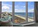 Living area showcasing a picturesque ocean view from a large window and comfortable furnishings at 1321 S Ocean Blvd. # 1101, North Myrtle Beach, SC 29582