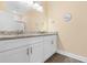 Modern bathroom featuring a granite countertop, white cabinets, and wood-look floors at 136 Birch N Coppice Dr. # 11, Surfside Beach, SC 29575