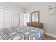 Bright bedroom featuring a patterned quilt, wood flooring, and light wood dresser with mirror at 136 Birch N Coppice Dr. # 11, Surfside Beach, SC 29575