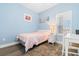 Cozy bedroom features blue walls, a plush rug, a single bed, and a white writing desk at 136 Birch N Coppice Dr. # 11, Surfside Beach, SC 29575