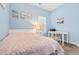 Comfortable bedroom features blue walls, a plush rug, a single bed, and a white writing desk at 136 Birch N Coppice Dr. # 11, Surfside Beach, SC 29575