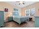 Comfortable bedroom with serene color palette, wood-look floors, and a large window at 136 Birch N Coppice Dr. # 11, Surfside Beach, SC 29575