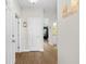 Hallway with wood floors, white doors and trim, and a decorative welcome sign at 136 Birch N Coppice Dr. # 11, Surfside Beach, SC 29575