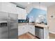 Open kitchen with granite countertops, stainless steel appliances and bright blue walls at 136 Birch N Coppice Dr. # 11, Surfside Beach, SC 29575