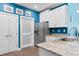 Modern kitchen with stainless steel refrigerator, granite countertop and blue walls at 136 Birch N Coppice Dr. # 11, Surfside Beach, SC 29575