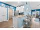Bright kitchen features blue walls, granite counters, white cabinets and stainless steel appliances at 136 Birch N Coppice Dr. # 11, Surfside Beach, SC 29575