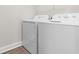 A white, front-loading washer and dryer sit in a modern laundry room at 136 Birch N Coppice Dr. # 11, Surfside Beach, SC 29575