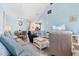 Inviting living room featuring light blue walls, wood floors, and comfortable seating area at 136 Birch N Coppice Dr. # 11, Surfside Beach, SC 29575