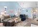 Living room with blue walls, hardwood floors, recliners, a sofa and access to the kitchen at 136 Birch N Coppice Dr. # 11, Surfside Beach, SC 29575