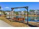 Scenic pond view with fountain and swing bench at 136 Birch N Coppice Dr. # 11, Surfside Beach, SC 29575