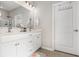 Bathroom with double vanity sinks, white cabinets, and a large mirror at 1377 Tessera Way, Myrtle Beach, SC 29579