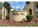 Elegant Bella Vita community sign surrounded by colorful flowers and lush greenery at 1377 Tessera Way, Myrtle Beach, SC 29579