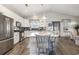 Bright kitchen with stainless steel appliances, a large island with seating, and hardwood floors at 1377 Tessera Way, Myrtle Beach, SC 29579