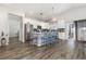 Modern kitchen with white cabinets, stainless steel appliances, granite countertops and a large island at 1377 Tessera Way, Myrtle Beach, SC 29579