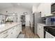 Bright kitchen featuring white cabinets, granite countertops, and stainless steel appliances at 1377 Tessera Way, Myrtle Beach, SC 29579