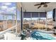 Relaxing screened porch features ceiling fan, bench seating, and peaceful views of pond and backyard at 1377 Tessera Way, Myrtle Beach, SC 29579