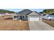 Single-story house with gray siding, white garage door, and a front porch at 142 Bancroft Dr., Conway, SC 29527