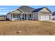 Gray house with a white garage door and a porch with columns at 142 Bancroft Dr., Conway, SC 29527