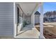 Covered porch with white columns, potted plants, and a bench at 142 Bancroft Dr., Conway, SC 29527