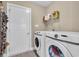 Bright laundry room, features washer, dryer, and storage at 142 Bancroft Dr., Conway, SC 29527