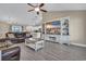 Open living room with hardwood floors, a large TV, and a view into the kitchen at 142 Bancroft Dr., Conway, SC 29527