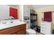 Bathroom with a wooden vanity, toilet, storage cabinet, and neutral color scheme at 1425 Tiger Grand Dr., Conway, SC 29526