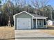 Newly constructed house with a green exterior and a two-car garage at 150 Honeydew Rd., Myrtle Beach, SC 29588