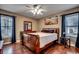 Bedroom with wooden sleigh bed and ceiling fan at 1500 Docksider Ct., Surfside Beach, SC 29575