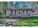 Gray house with a porch, rocking chairs, and American flags at 1500 Docksider Ct., Surfside Beach, SC 29575