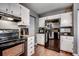 Modern kitchen with white cabinets and black appliances at 1500 Docksider Ct., Surfside Beach, SC 29575