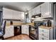 Well-equipped kitchen featuring white cabinets and black appliances at 1500 Docksider Ct., Surfside Beach, SC 29575