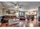 Open living room with hardwood floors, brown leather furniture, and a kitchen view at 1500 Docksider Ct., Surfside Beach, SC 29575