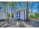 White storage shed with blue doors and a wooden ramp at 1500 Docksider Ct., Surfside Beach, SC 29575