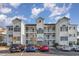 Attractive condo building exterior with ample parking and well-kept landscaping at 1525 Lanterns Rest Rd. # 102, Myrtle Beach, SC 29579