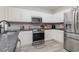 Bright kitchen featuring modern appliances, granite countertops and white cabinetry at 1525 Lanterns Rest Rd. # 102, Myrtle Beach, SC 29579