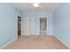 Comfortable bedroom with light blue walls, beige carpet, a ceiling fan, and ensuite access to a private bath at 1538 Lanterns Rest Rd. # 103, Myrtle Beach, SC 29579