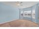 Well-lit bedroom with bay window, ceiling fan, and neutral carpet at 1538 Lanterns Rest Rd. # 103, Myrtle Beach, SC 29579