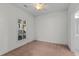 Bright bedroom featuring a large window with blinds, neutral walls, carpet, and a ceiling fan with overhead lighting at 1538 Lanterns Rest Rd. # 103, Myrtle Beach, SC 29579