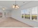 Bright living room featuring a chandelier, neutral carpet, and sliding doors to an outdoor space at 1538 Lanterns Rest Rd. # 103, Myrtle Beach, SC 29579